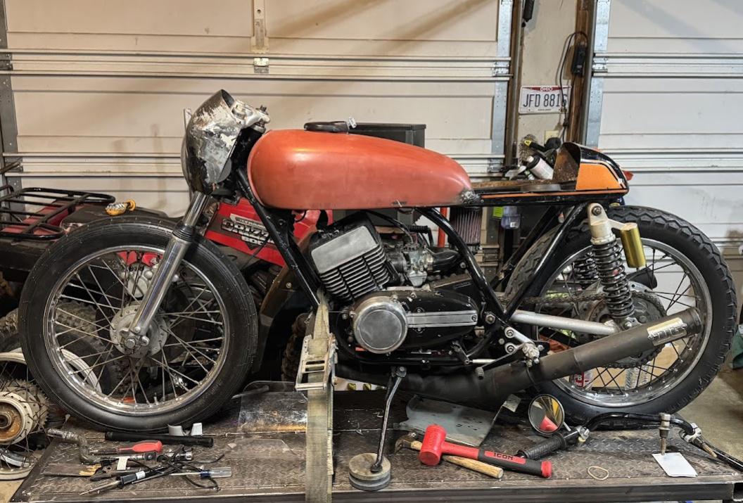 The RD350 cafe racer outside in the sun